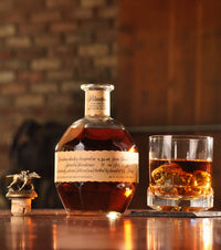 Blanton's Original Single Barrel bourbon bottle beside a poured glass, neat