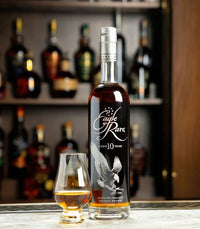 Eagle Rare 10 Year bourbon poured neat beside the bottle